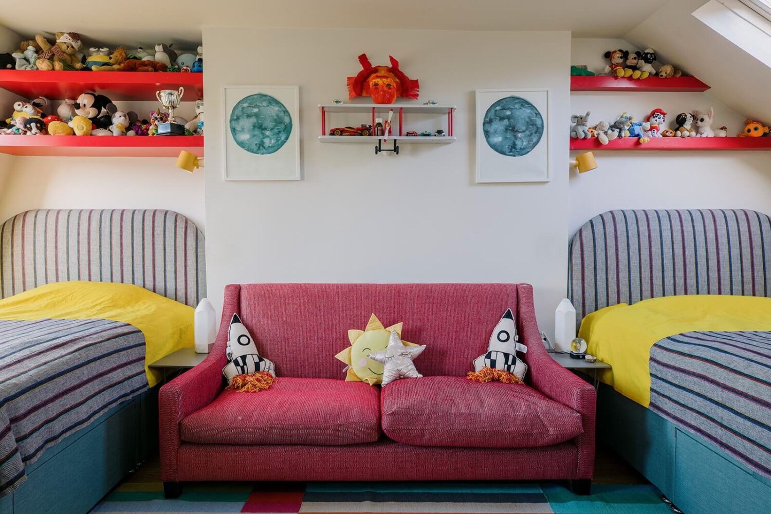 A Unique Colorful Family Home in London 16 double-kids-bedroom-pink-sofa-slanted-ceiling-shelves-nordroom