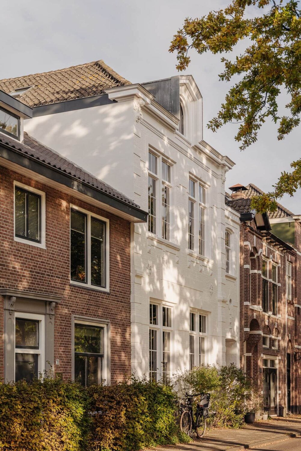 A Unique Black and White Home in a Former School Building 1 exterior-street-white-townhouse-netherlands-nordroom