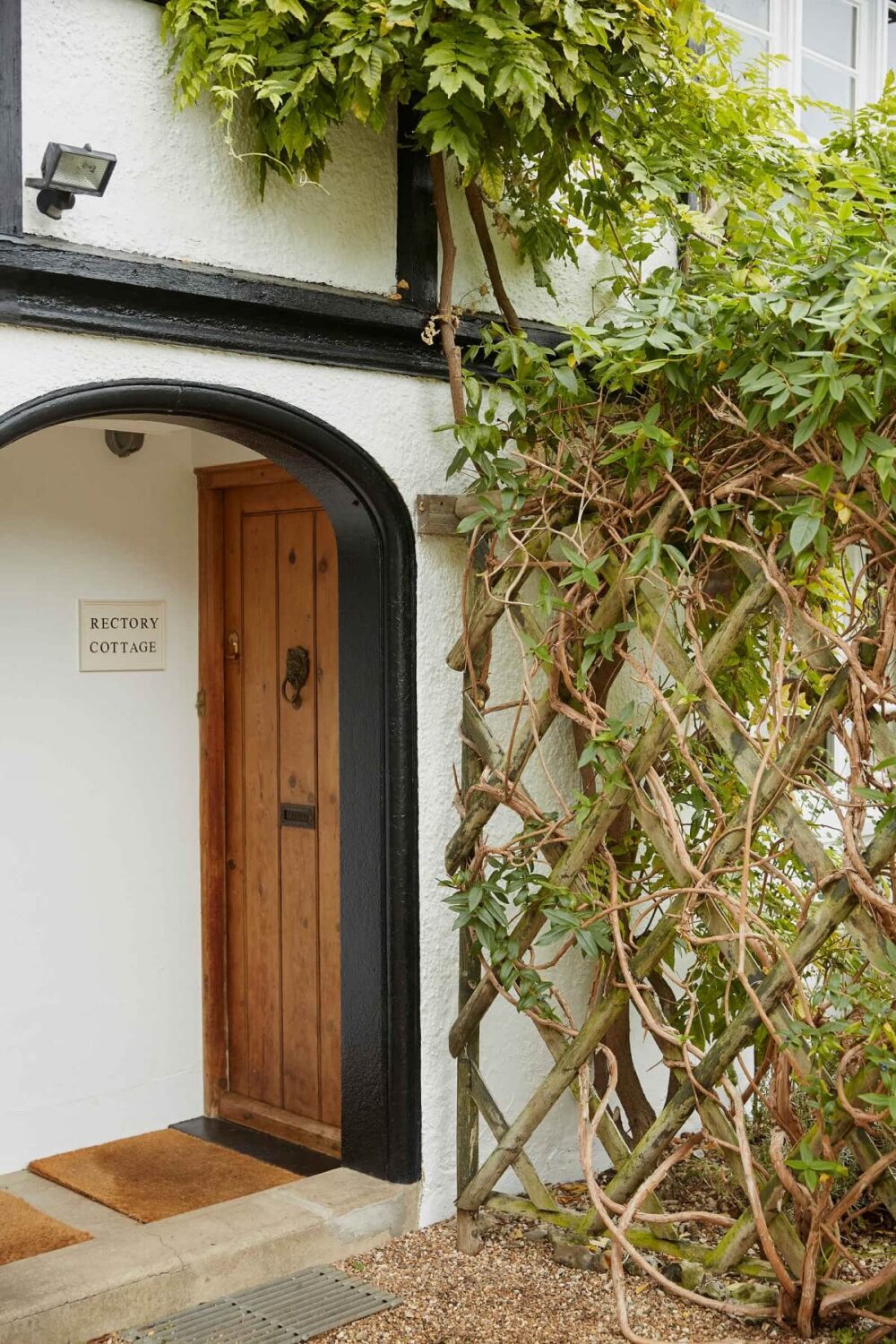 A Charming Arts and Crafts Cottage in the English Countryside 23 front-door-arched-entry-english-cottage-nordroom