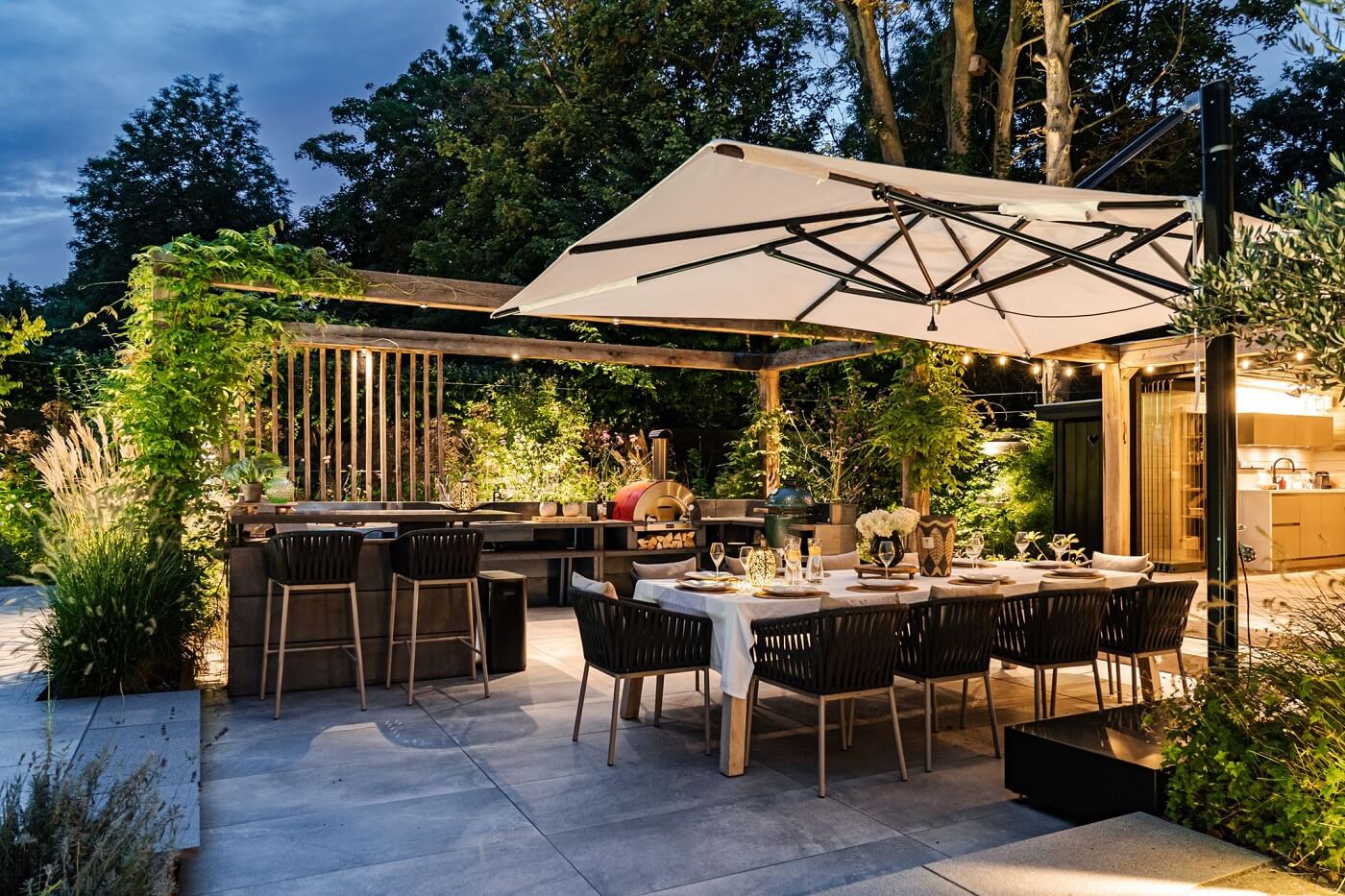 A Luxurious Dutch Villa in a Former Carriage House 32 garden-dining-area-at-night-nordroom