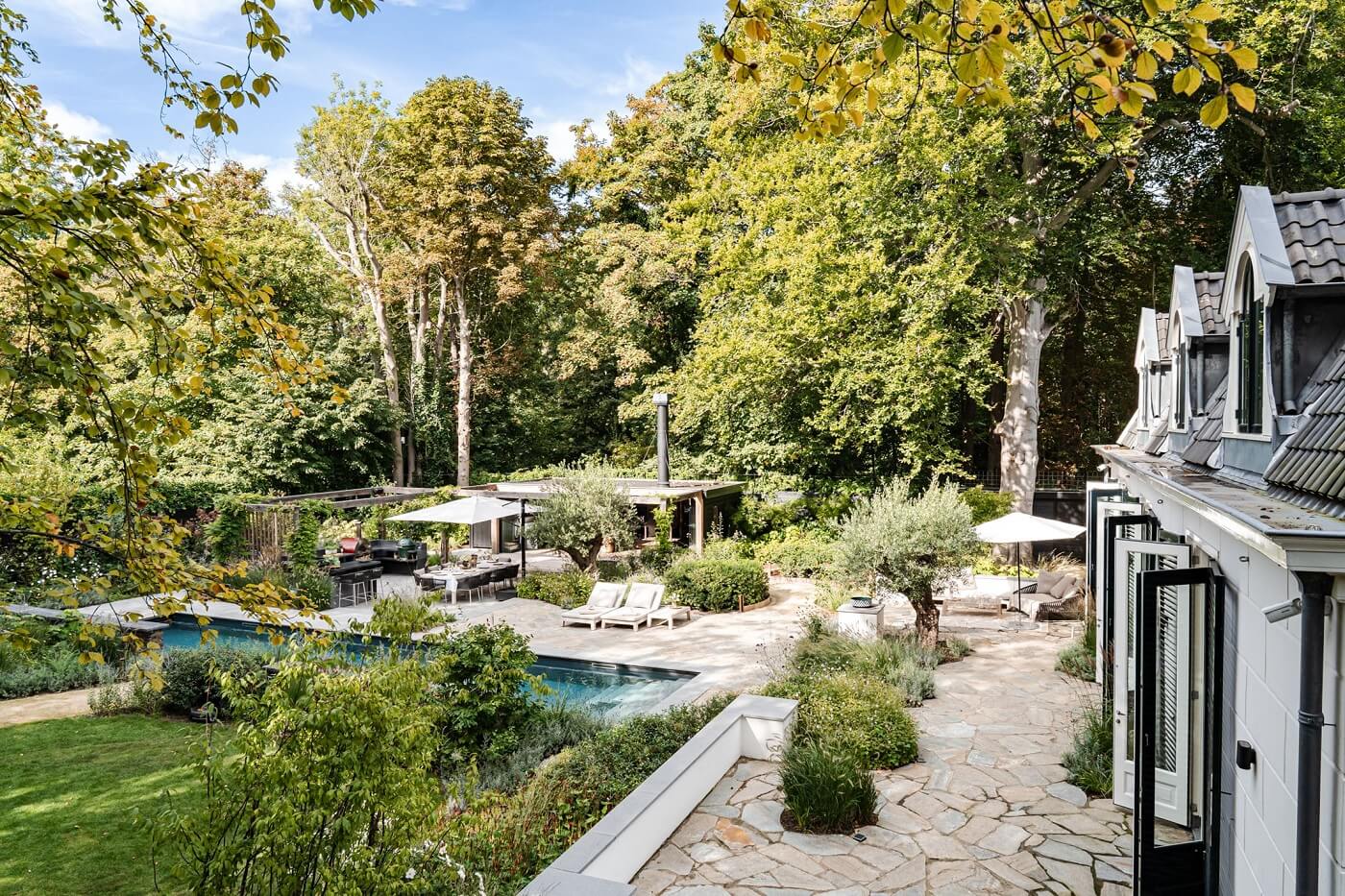 A Luxurious Dutch Villa in a Former Carriage House 24 garden-pool-trees-dutch-carriage-house-nordroom