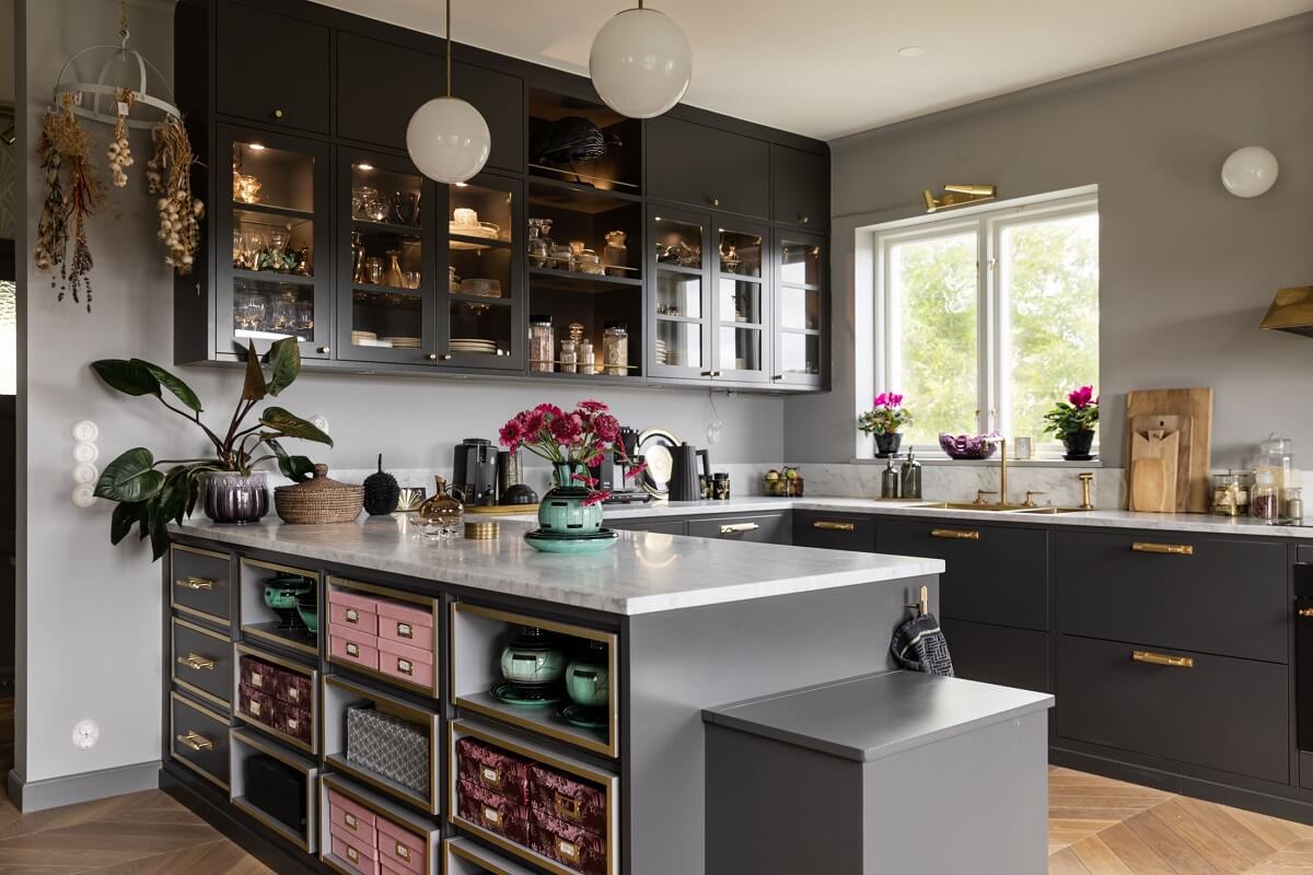 A Scandinavian Home with Purple Color Accents 12 gray-kitchen-brass-fittings-glass-cabinets-nordroom