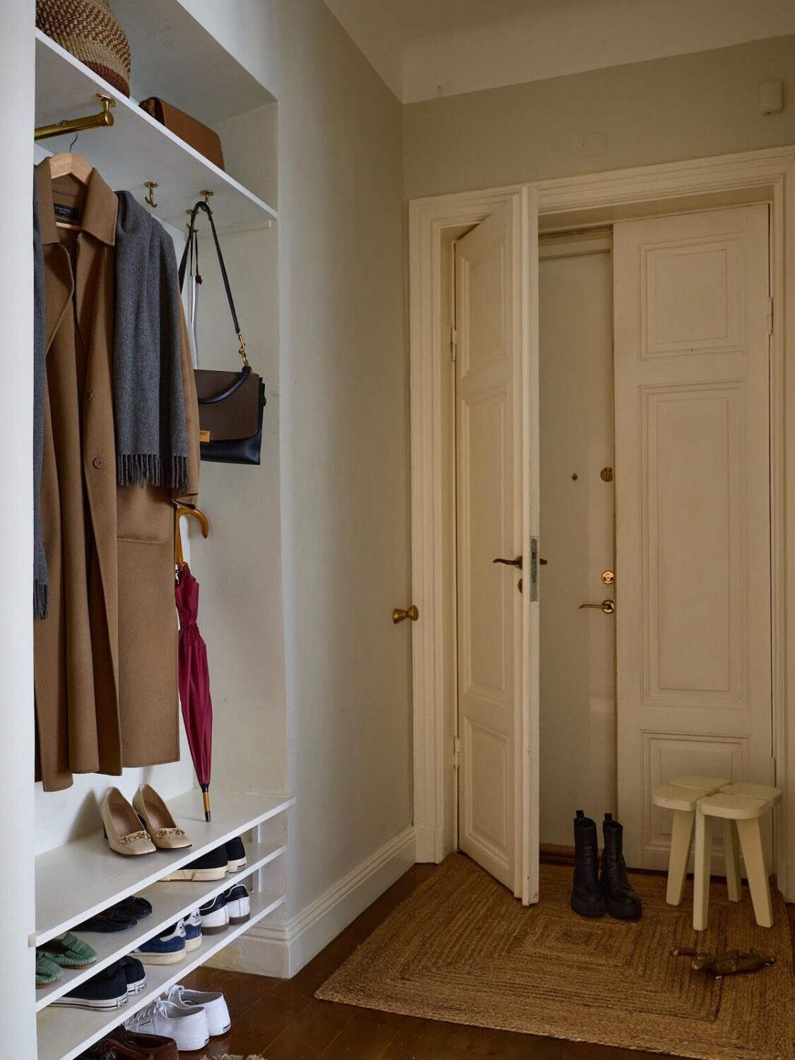 A Charming Vintage Apartment in Stockholm 14 hallway-builtin-wardrobe-light-blue-gray-walls-nordroom