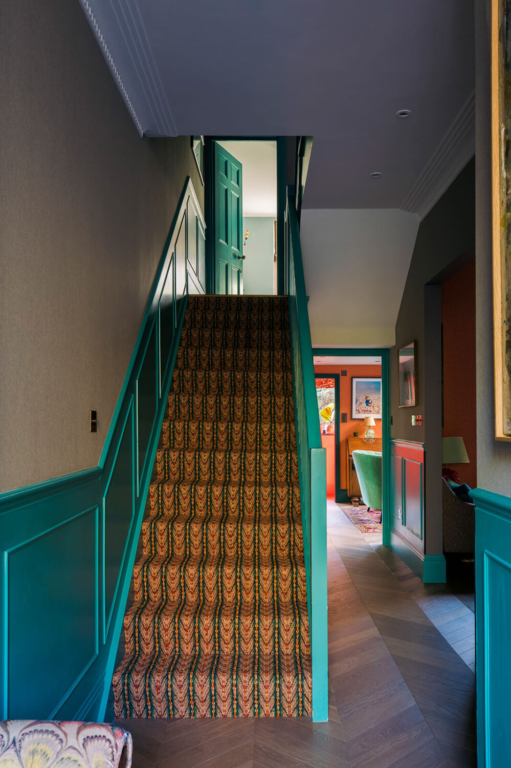 Herringbone vs. Chevron Flooring Patterns: Differences & Inspiration 9 hallway-green-paneling-chevron-floor-colorful-family-home-nordroom