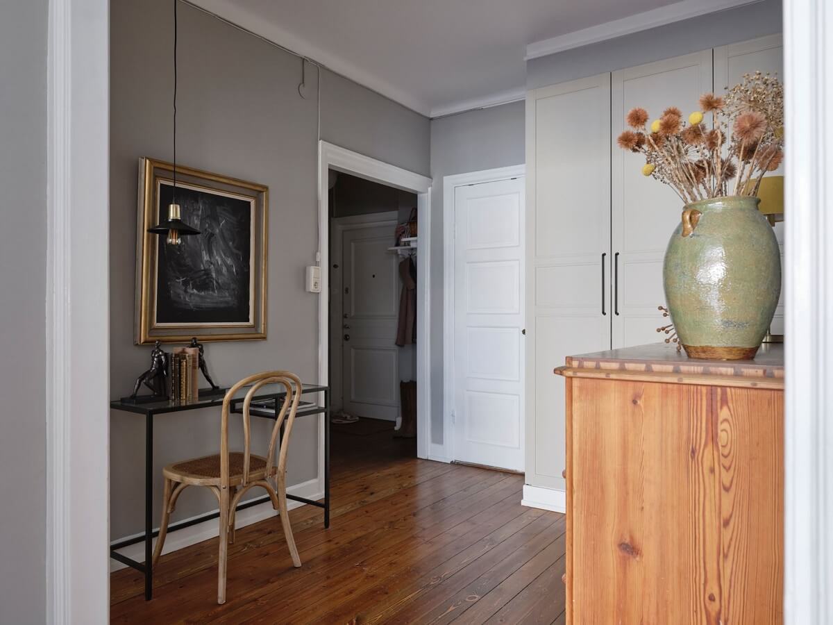 A Small Nordic Home with Dark Blue Accent Walls 9 hallway-light-gray-walls-home-office-built-in-closet-nordroom