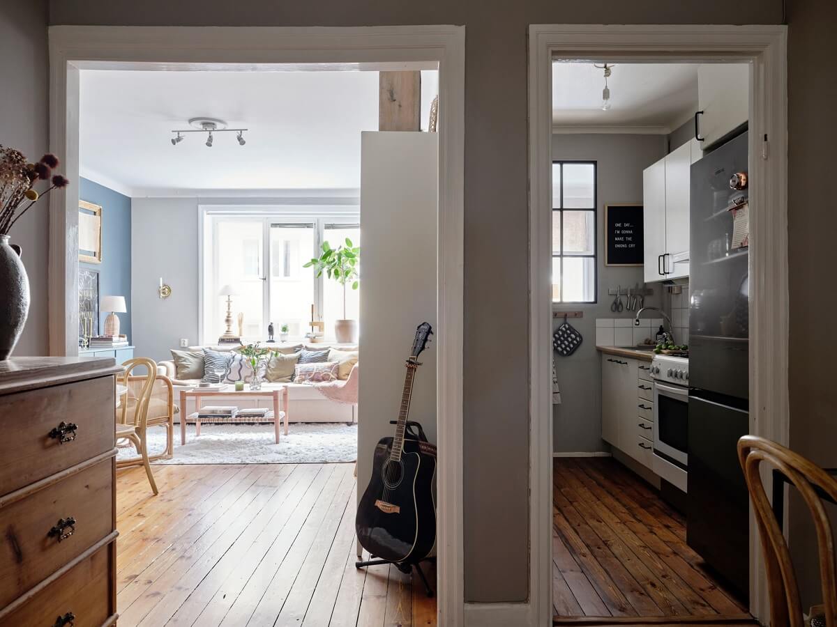 A Small Nordic Home with Dark Blue Accent Walls 10 hallway-wooden-floor-small-galley-kitchen-gray-walls-nordroom