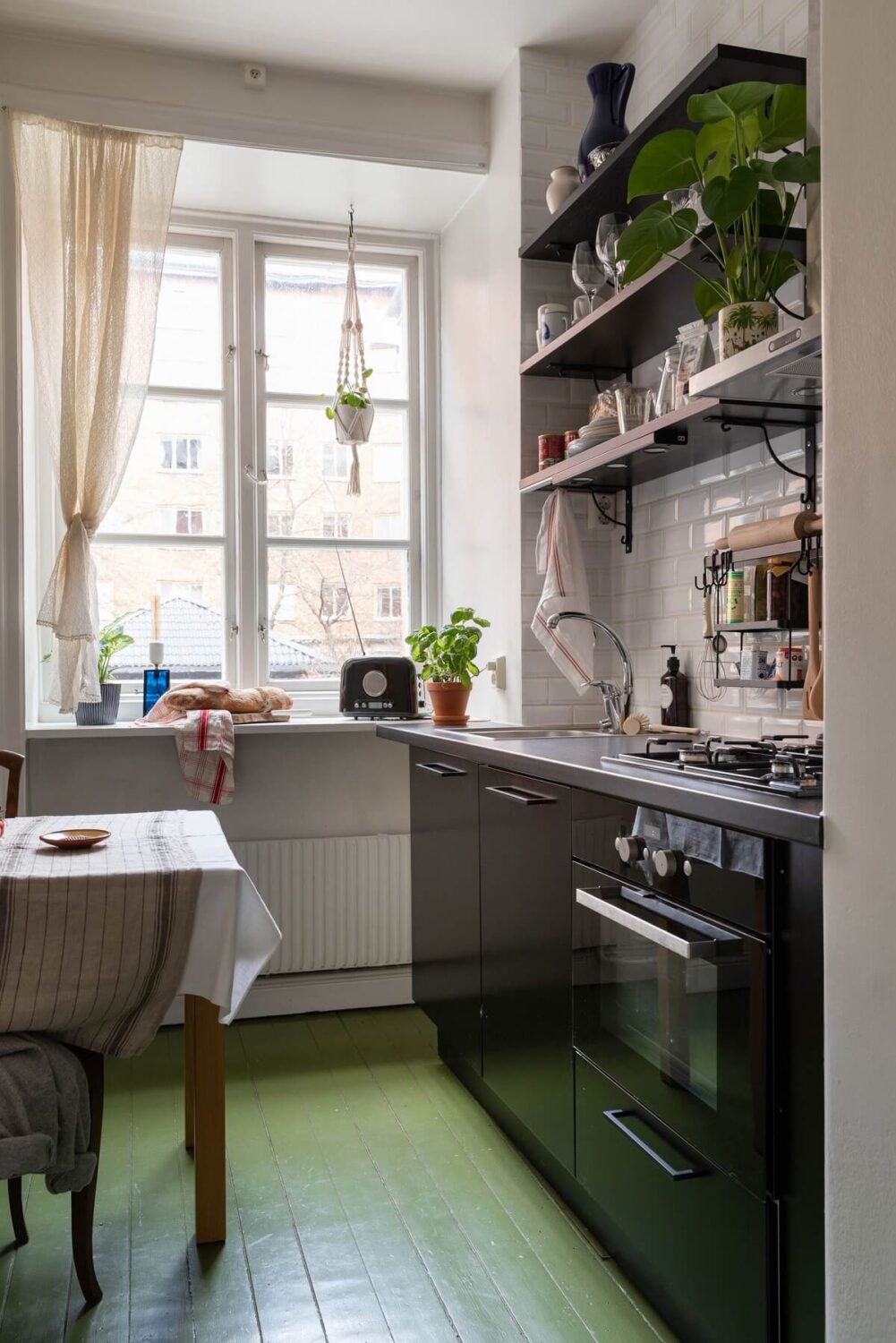 A Colored Sixth Wall May Be The Biggest Paint Trend in 2026 23 kitchen-black-cabinets-open-shelves-green-painted-floor-nordroom