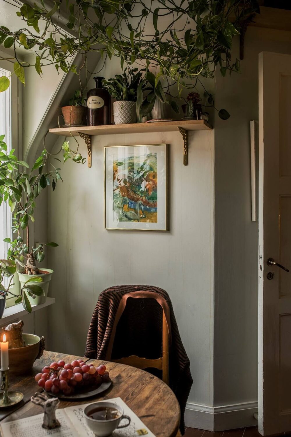 A Cozy Green Kitchen in a Vintage Attic Apartment 7 kitchen-nook-shelf-plants-slanted-wall-nordroom