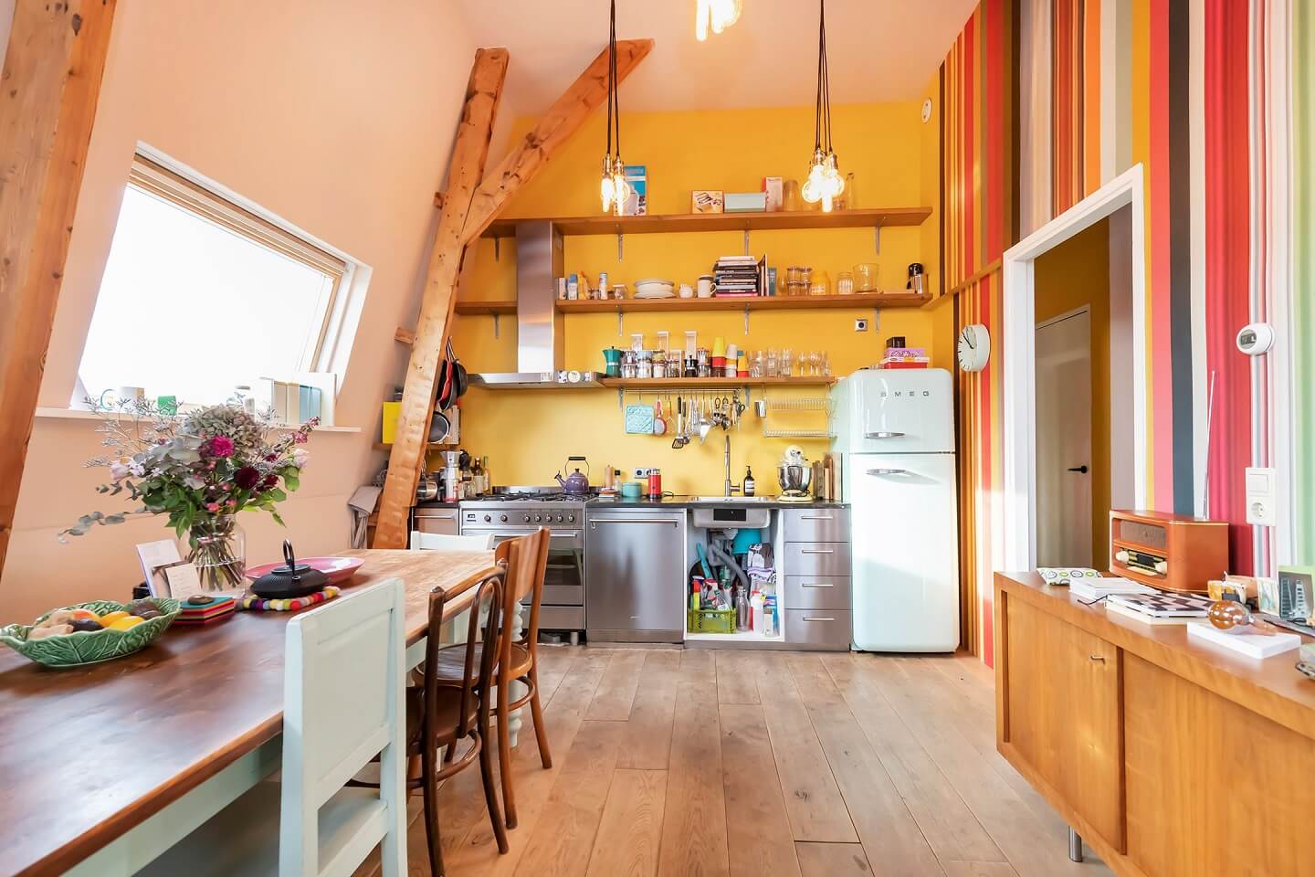 A Colorful Loft in Amsterdam with Exposed Wooden Beams 15 kitchen-yellow-walls-shelves-colorful-loft-nordroom