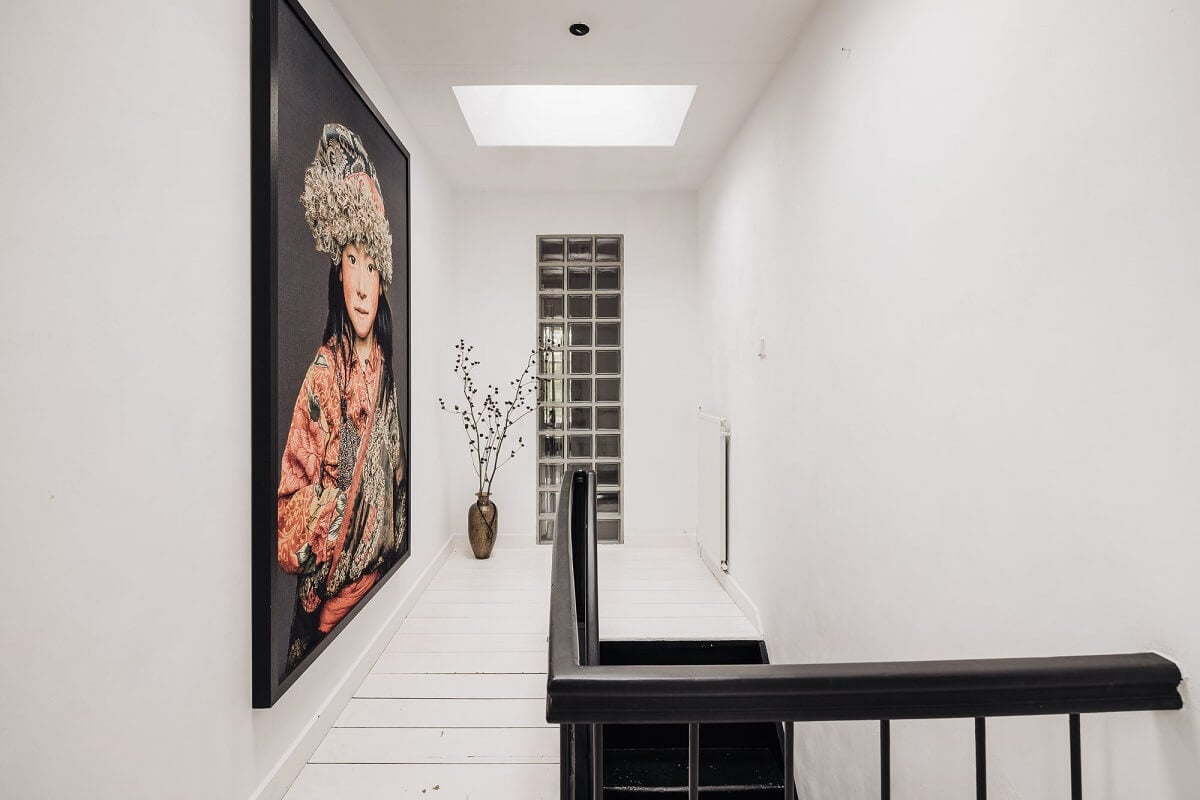 A Unique Black and White Home in a Former School Building 21 landing-white-floor-walls-large-art-black-stairs-nordroom