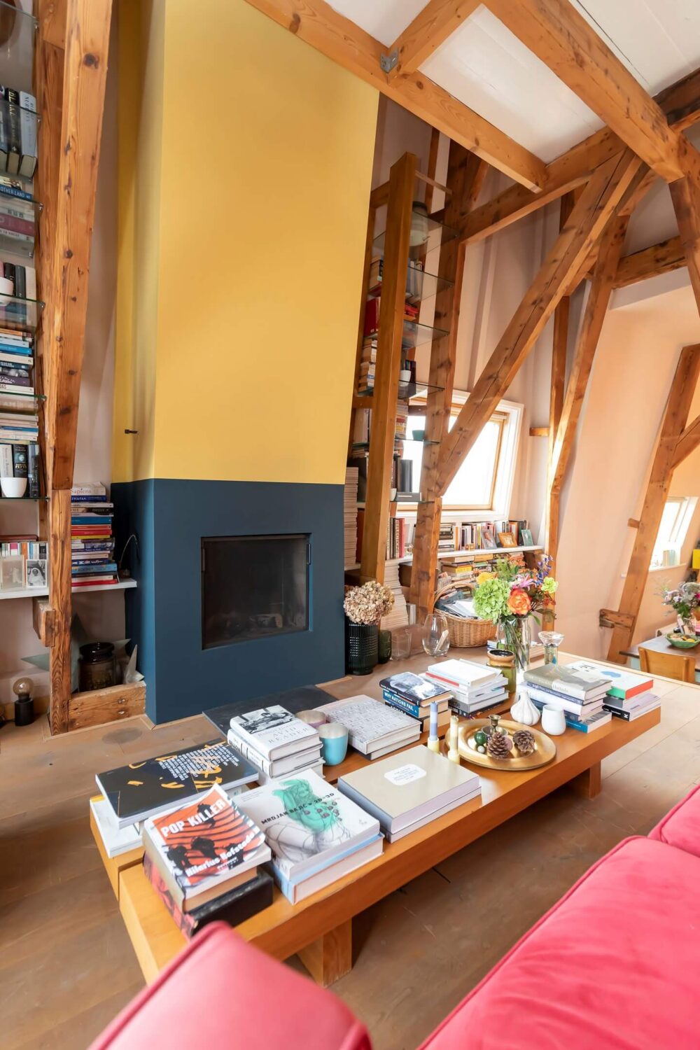 A Colorful Loft in Amsterdam with Exposed Wooden Beams 5 living-area-fireplace-wooden-beams-colorful-loft-nordroom
