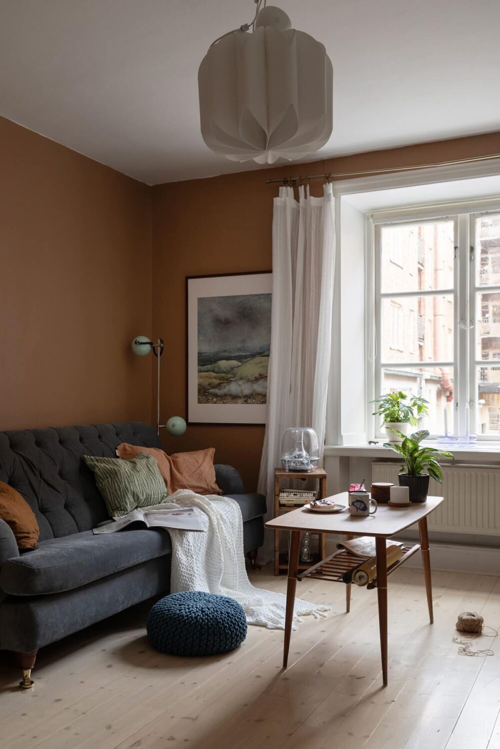 A Cozy Apartment Painted in Warm Natural Colors 2 living-room-brown-walls-small-apartment-nordroom