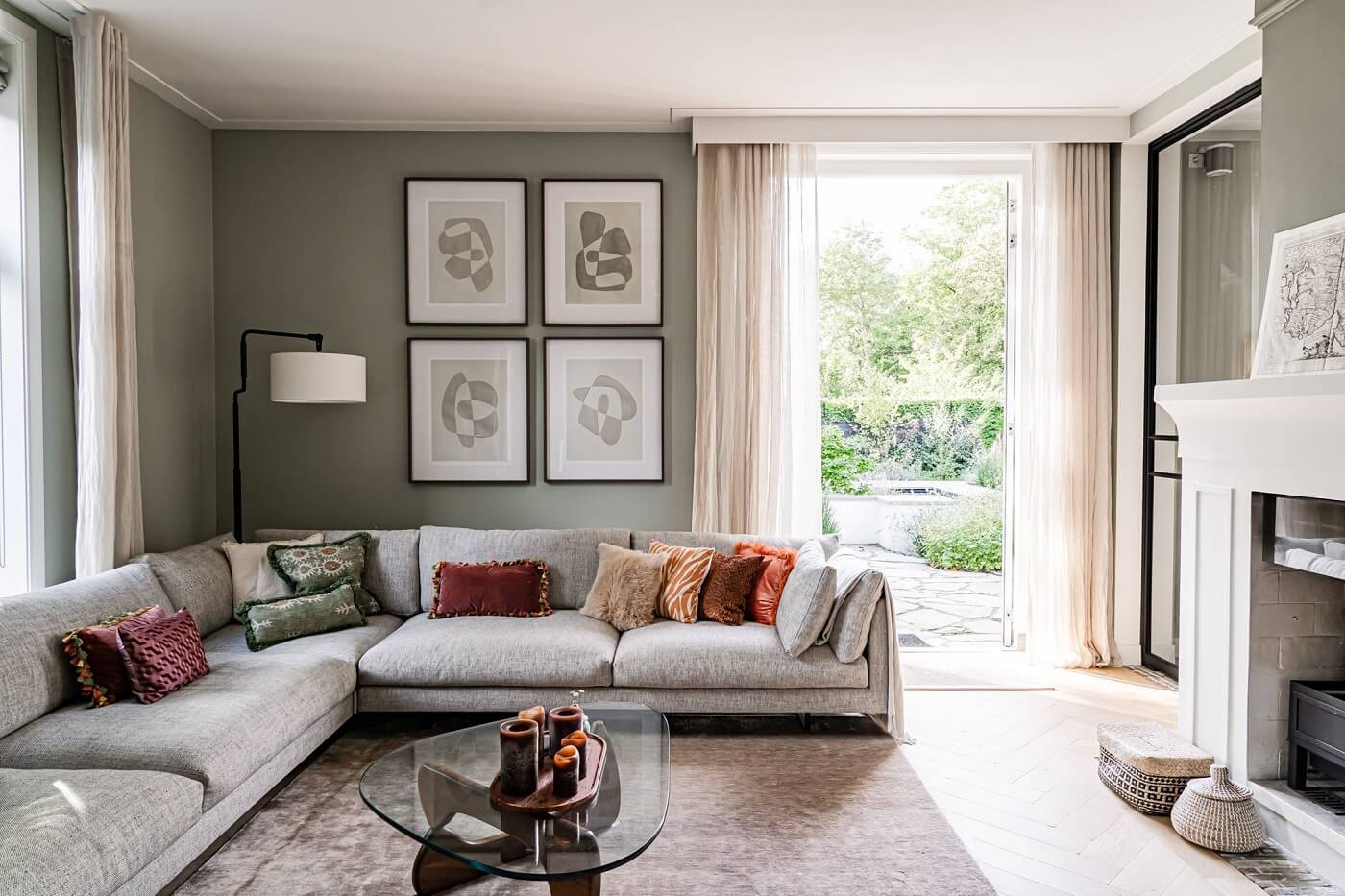 A Luxurious Dutch Villa in a Former Carriage House 8 living-room-corner-sofa-gray-walls-white-fireplace-nordroom