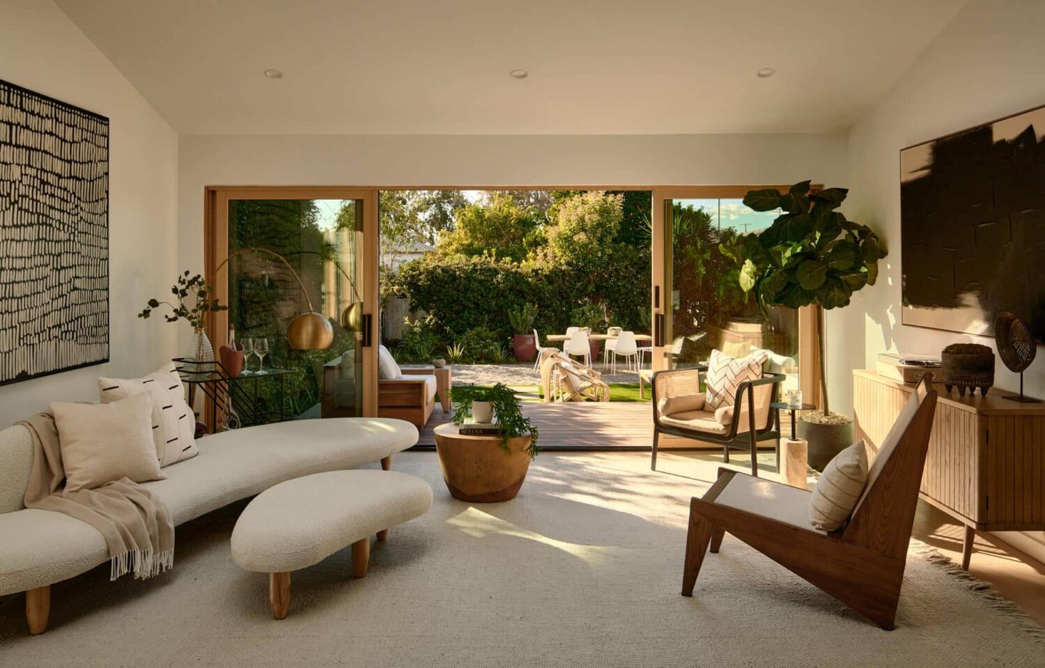 A Stylish Los Angeles Bungalow Renovated by a Designer 6 living-room-curved-couch-sliding-doors-garden-nordroom