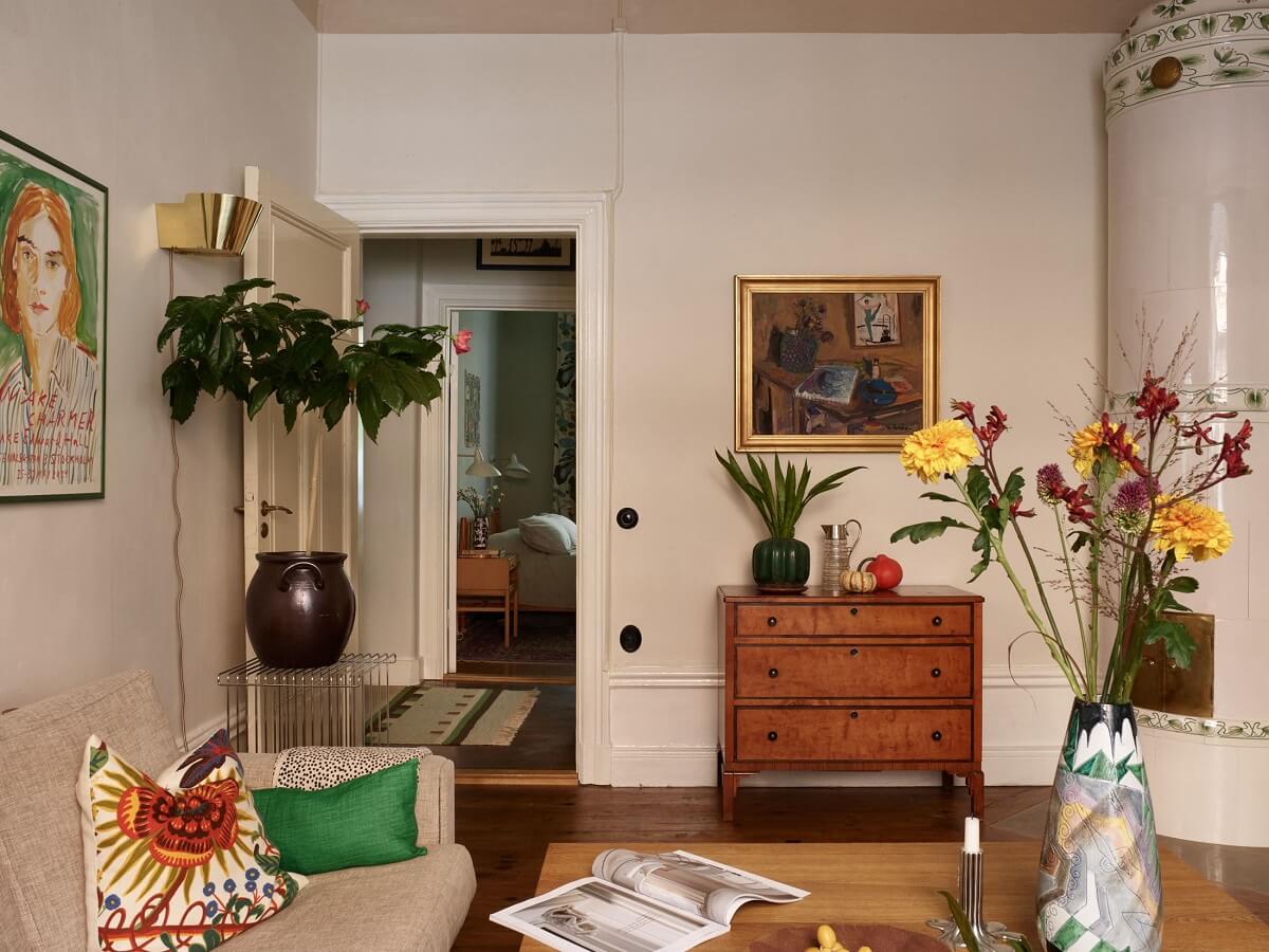 A Charming Vintage Apartment in Stockholm 5 living-room-wooden-floor-beige-walls-fireplace-nordroom