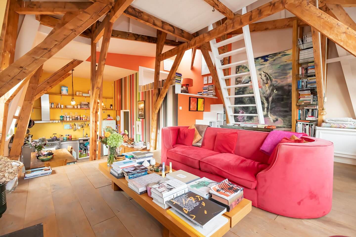 A Colorful Loft in Amsterdam with Exposed Wooden Beams 1 loft-apartment-amsterdam-exposed-beams-pink-couch-nordroom