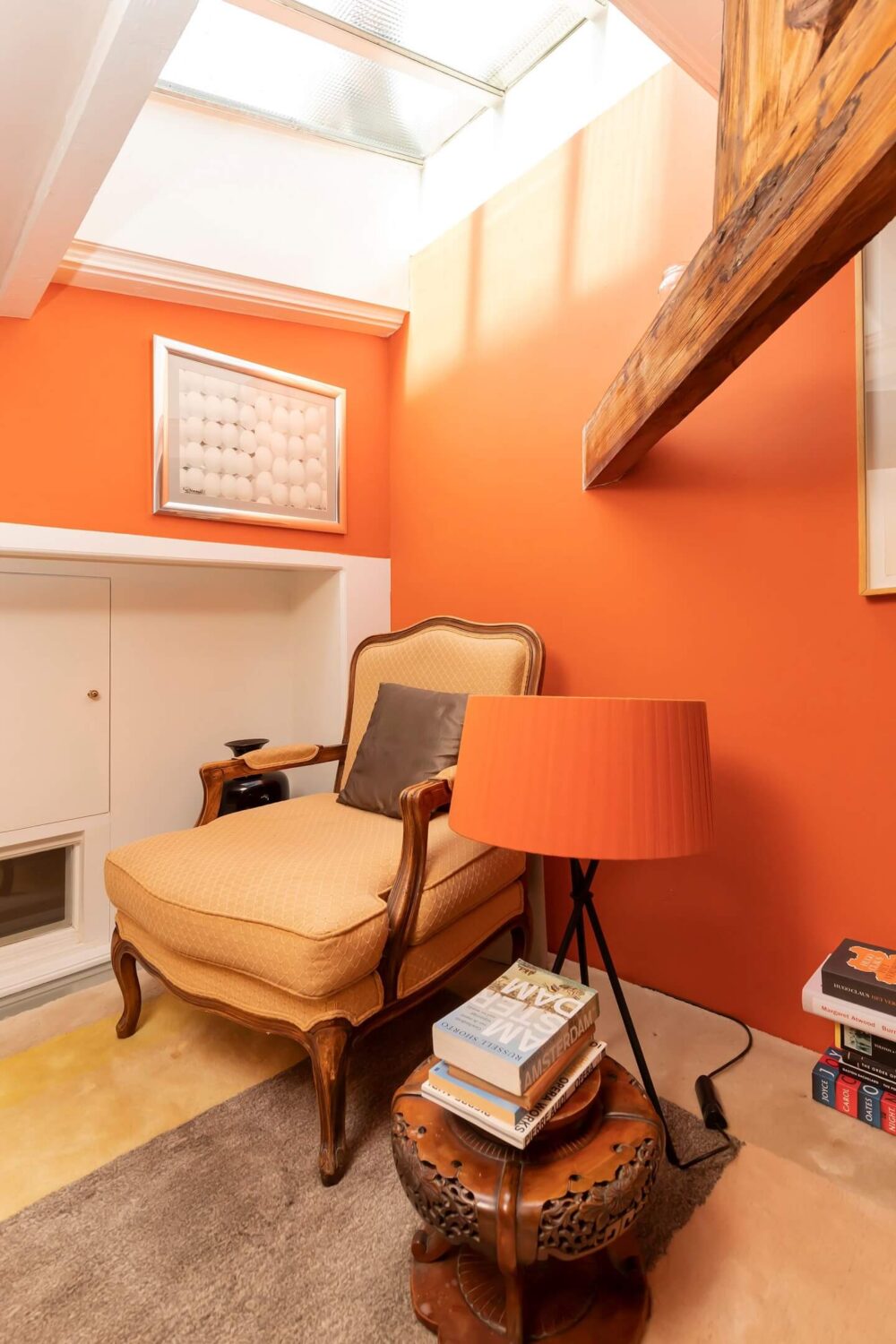 A Colorful Loft in Amsterdam with Exposed Wooden Beams 9 loft-reading-nook-orange-walls-wooden-beams-nordroom