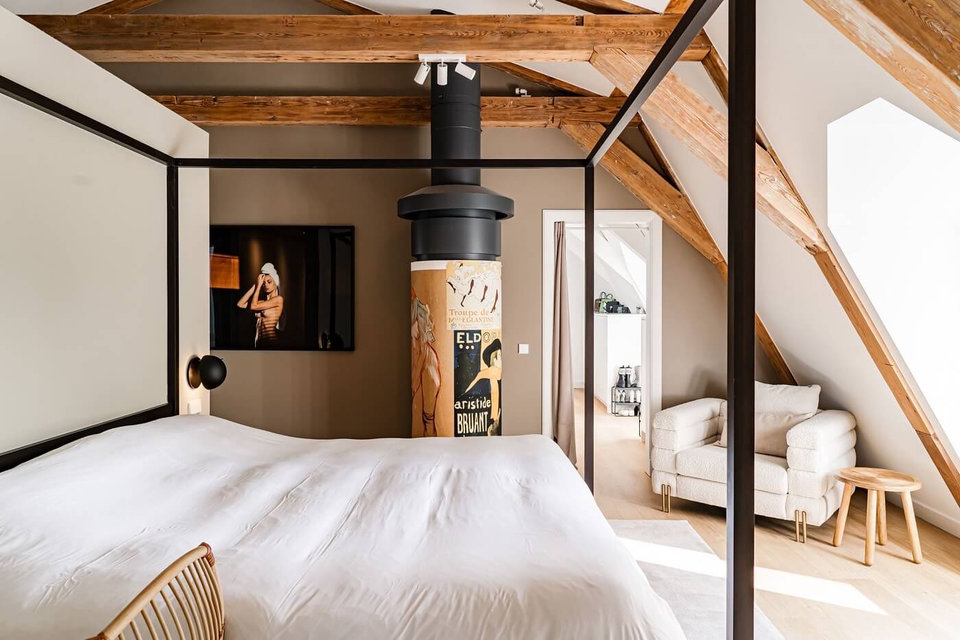 A Luxurious Dutch Villa in a Former Carriage House 17 master-bedroom-canopy-bed-exposed-beams-sloped-ceiling-nordroom