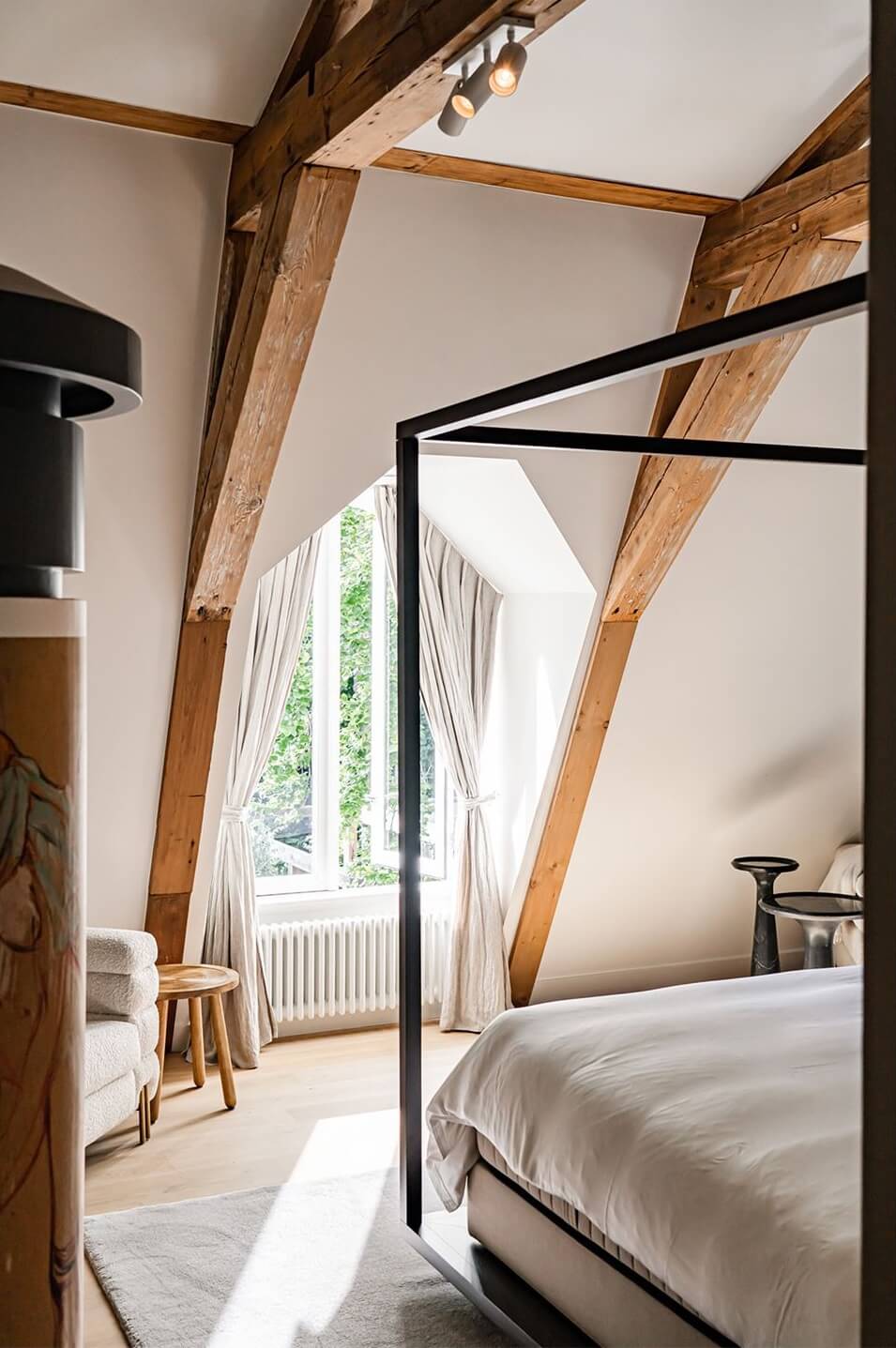 A Luxurious Dutch Villa in a Former Carriage House 19 master-bedroom-exposed-wooden-beams-slanted-ceiling-nordroom
