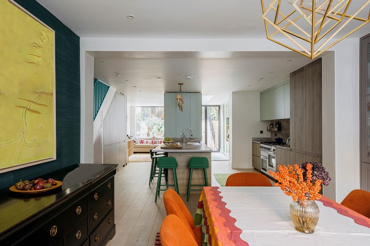 A Unique Colorful Family Home in London 4 open-plan-kitchen-dining-room-teal-wallpaper-orange-chairs-nordroom