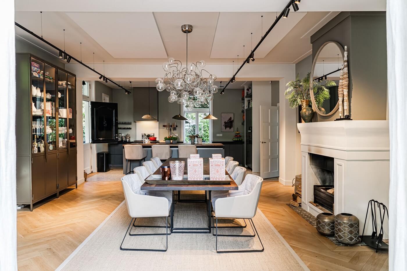 A Luxurious Dutch Villa in a Former Carriage House 11 open-plan-kitchen-dining-room-white-fireplace-nordroom