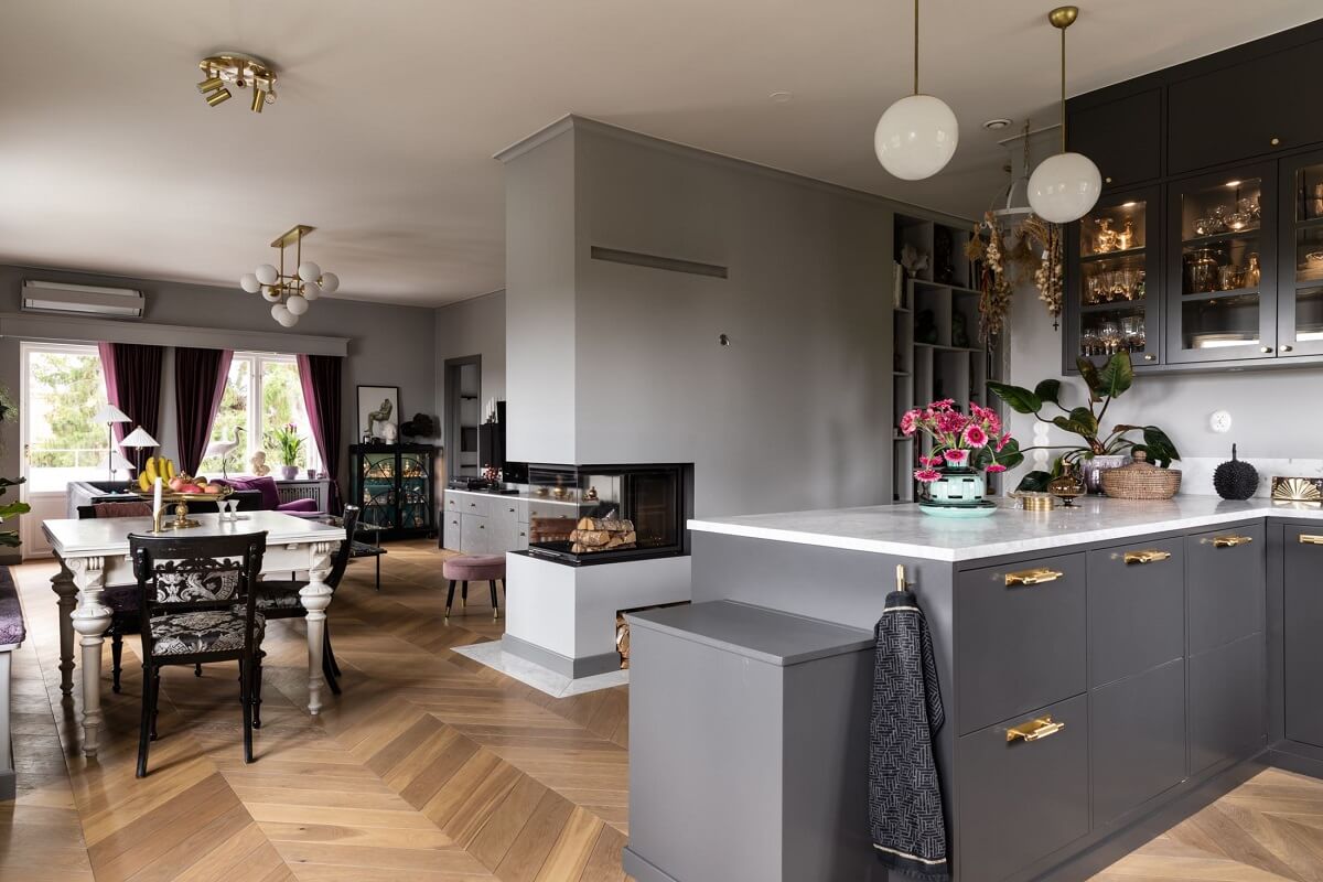 A Scandinavian Home with Purple Color Accents 10 open-plan-kitchen-living-room-gray-cabinets-nordroom