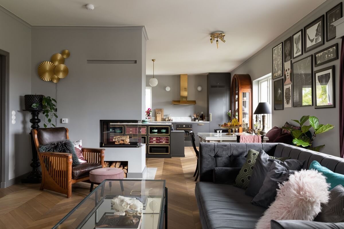 A Scandinavian Home with Purple Color Accents 2 open-plan-living-room-kitchen-gray-walls-fireplace-nordroom