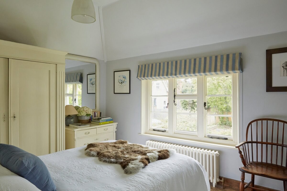 A Charming Arts and Crafts Cottage in the English Countryside 10 pale-blue-bedroom-walls-striped-curtains-nordroom