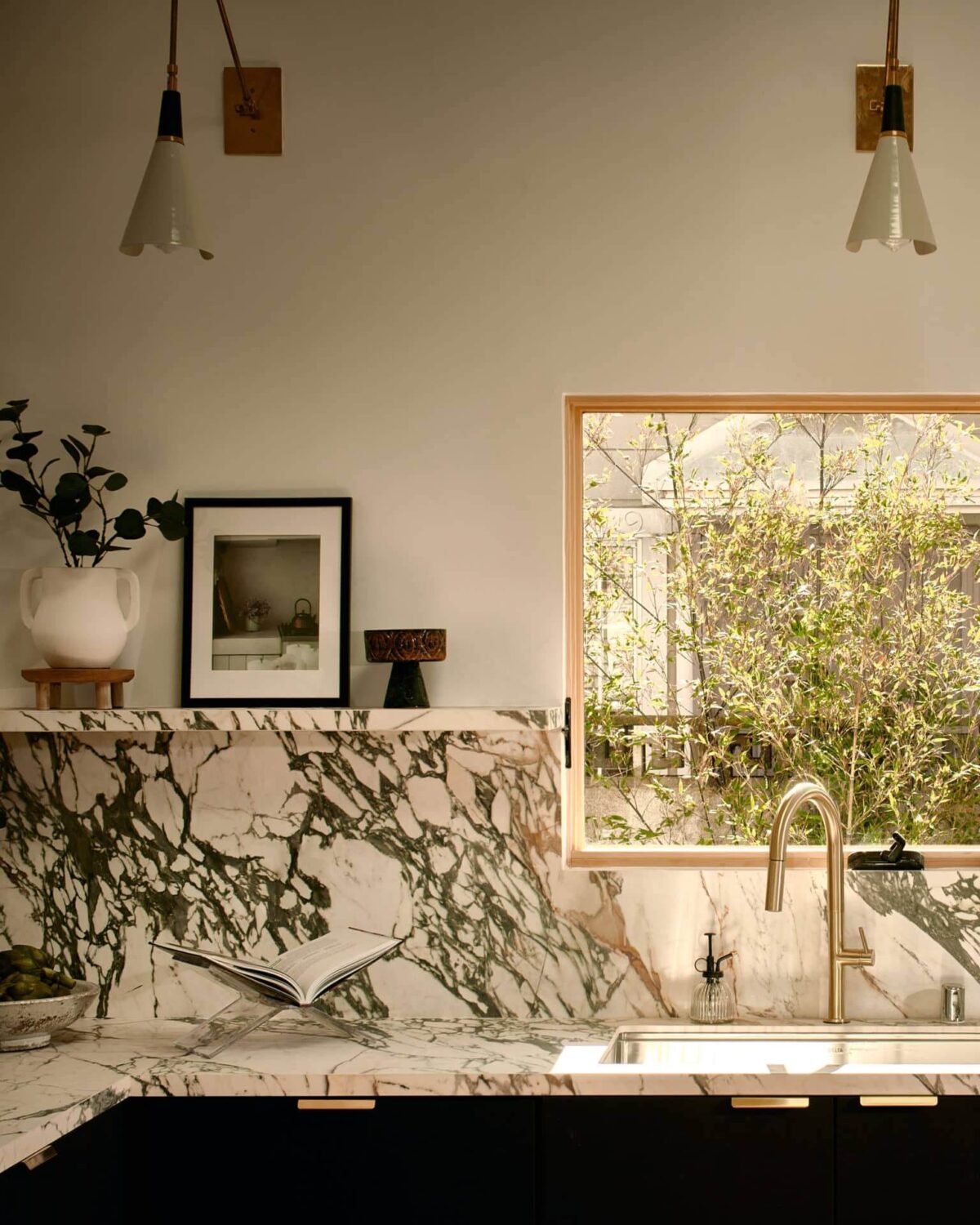 A Stylish Los Angeles Bungalow Renovated by a Designer 3 reform-kitchen-marble-backsplash-shelf-nordroom