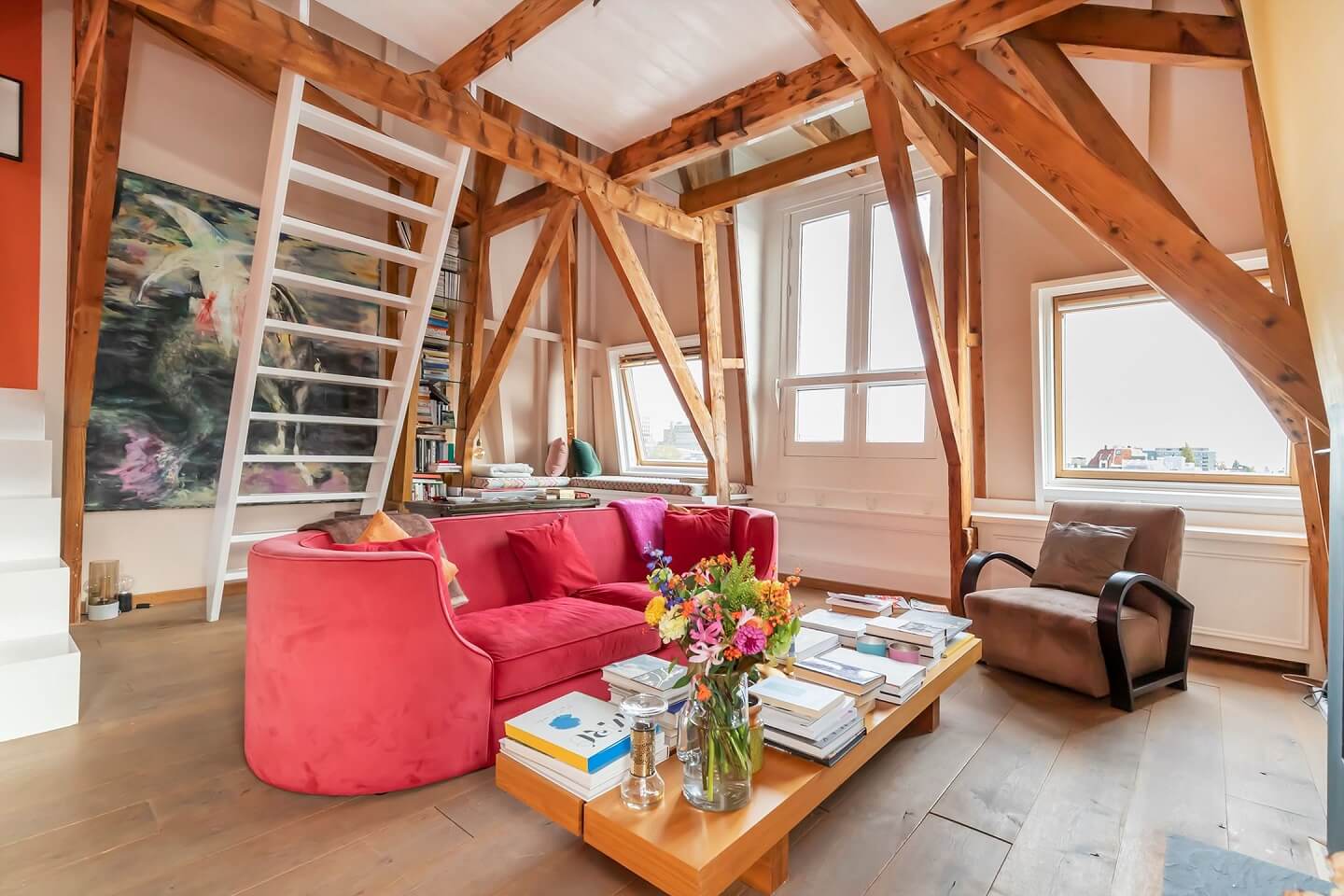 A Colorful Loft in Amsterdam with Exposed Wooden Beams 2 round-pink-sofa-colorful-loft-amsterdam-exposed-beams-nordroom