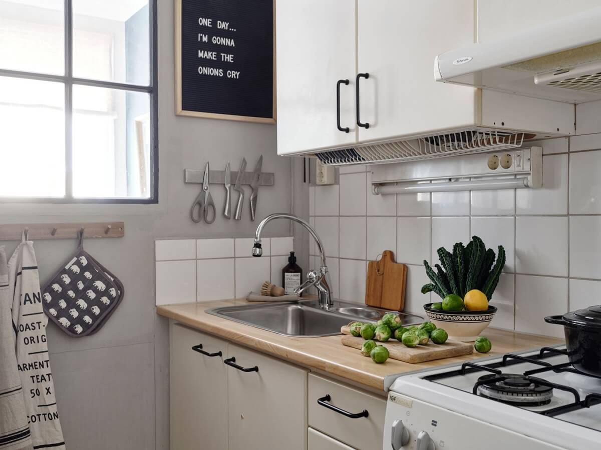 A Small Nordic Home with Dark Blue Accent Walls 12 small-galley-kitchen-indoor-window-light-gray-walls-nordroom