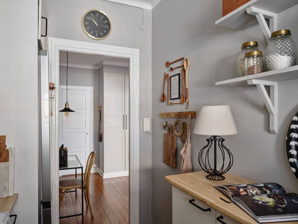 A Small Nordic Home with Dark Blue Accent Walls 13 small-galley-kitchen-light-gray-walls-shelves-nordroom