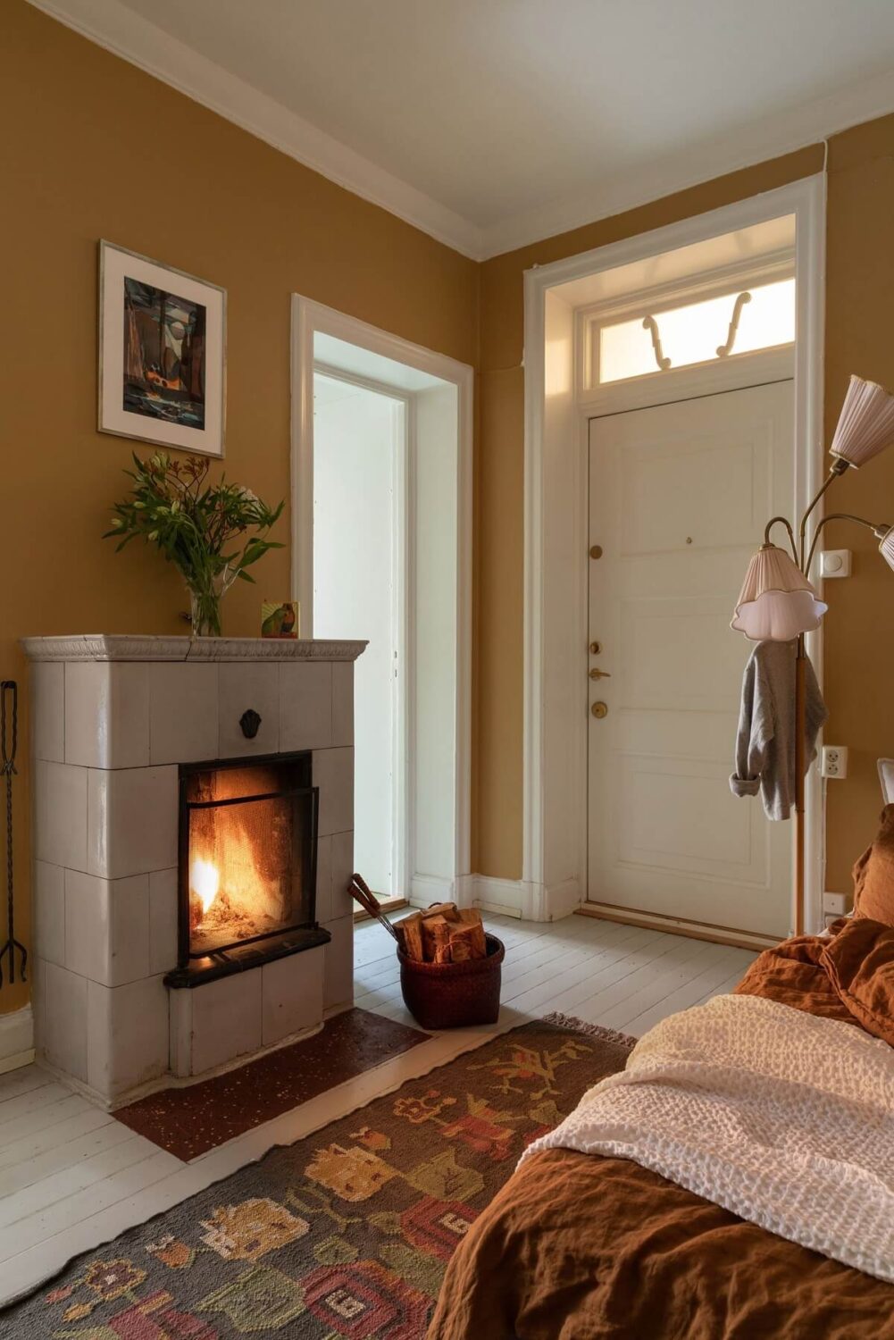 A Cozy Apartment Painted in Warm Natural Colors 12 small-hallway-turned-bedroom-firpelace-large-rug-nordroom