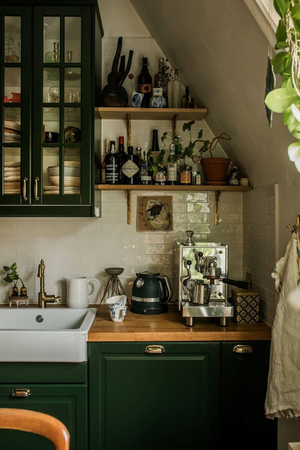 A Cozy Green Kitchen in a Vintage Attic Apartment 5 small-kitchen-green-cabinets-shelves-plants-nordroom