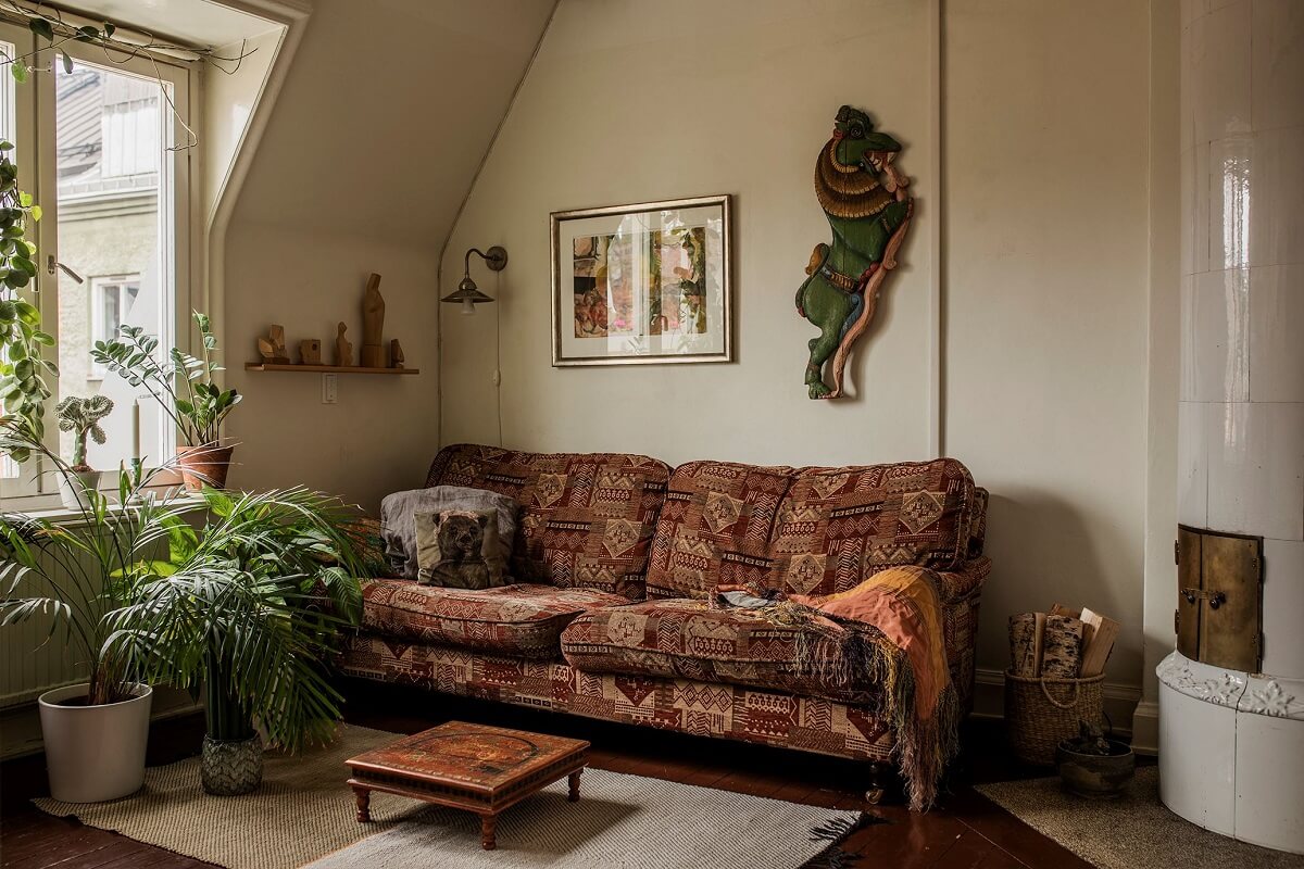A Cozy Green Kitchen in a Vintage Attic Apartment 12 small-living-room-printed-couch-firpelace-slanted-ceiling-nordroom