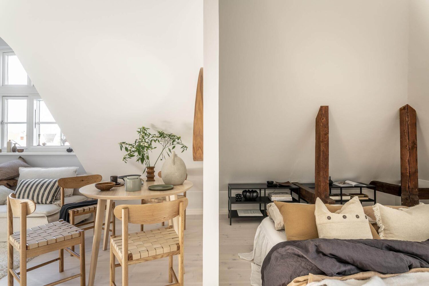 A Small Scandinavian Loft with Beautiful Natural Light 9 small-loft-dining-area-bedroom-area-exposed-beams-nordroom