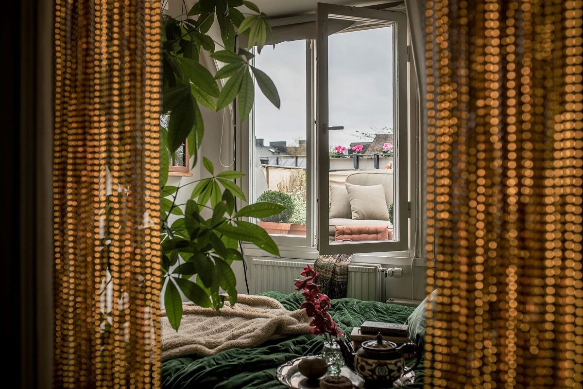 A Cozy Green Kitchen in a Vintage Attic Apartment 16 tiny-bedroom-balcony-green-bedding-nordroom