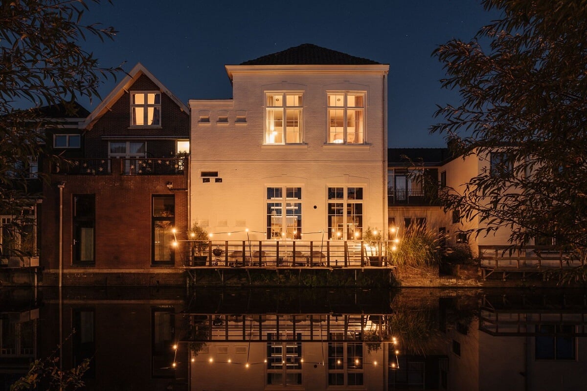 A Unique Black and White Home in a Former School Building 46 white-townhouse-at-night-canal-nordroom