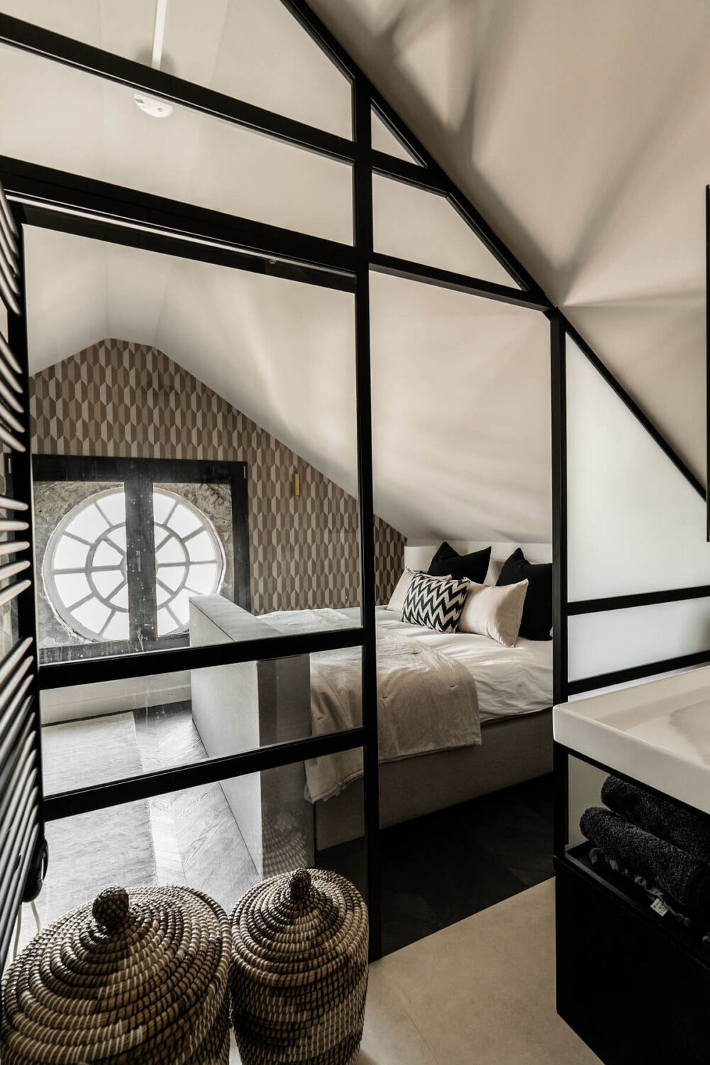 A Stylish Monochrome Penthouse in a Former Prison Building 25 attic-bedroom-slanted-ceiling-ensuite-bathroom-glass-wall-nordroom