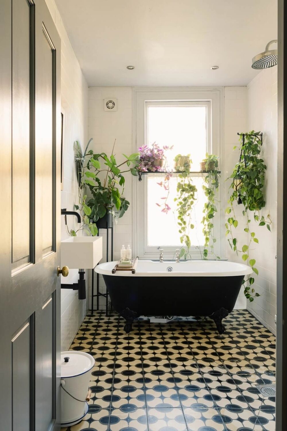 Inspiring Bathrooms With Geometric Tiles 13 bathroom-black-white-floor-tiles-plants-black-clawfoot-bath-nordroom