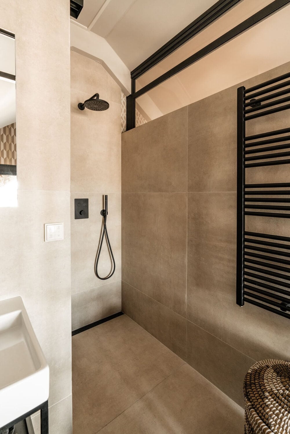A Stylish Monochrome Penthouse in a Former Prison Building 27 bathroom-gray-tiles-black-fittings-walk-in-shower-nordroom