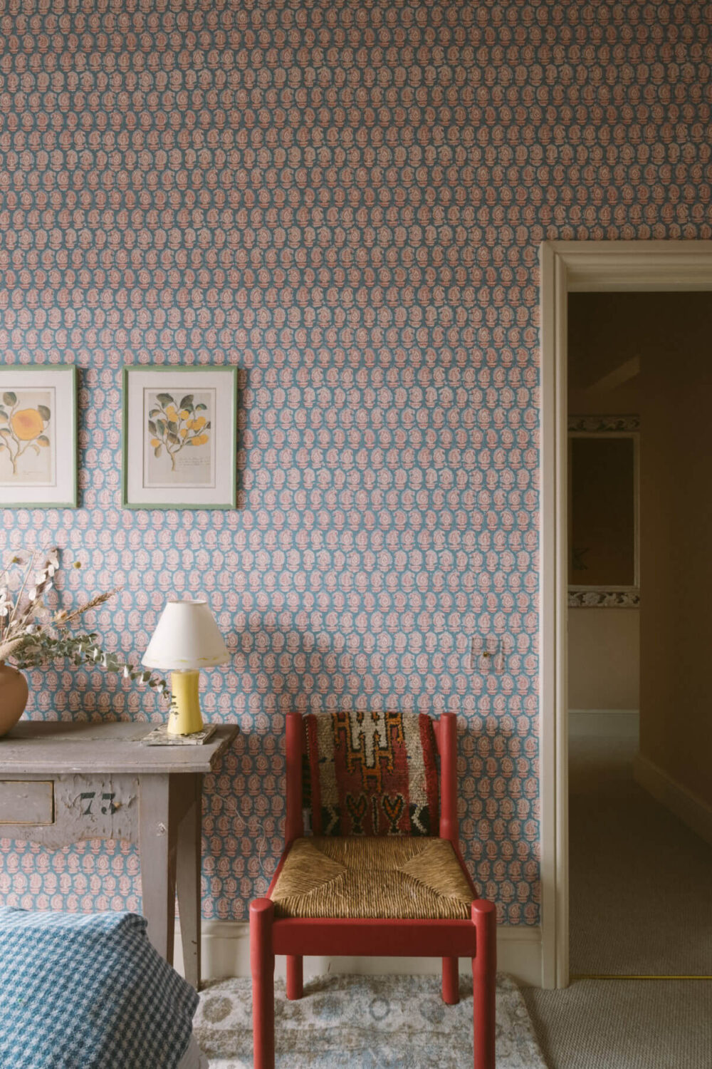 A Colorful Vintage Eclectic Home in England 30 bedroom-wallpaper-red-chair-vintage-eclectic-home-nordroom