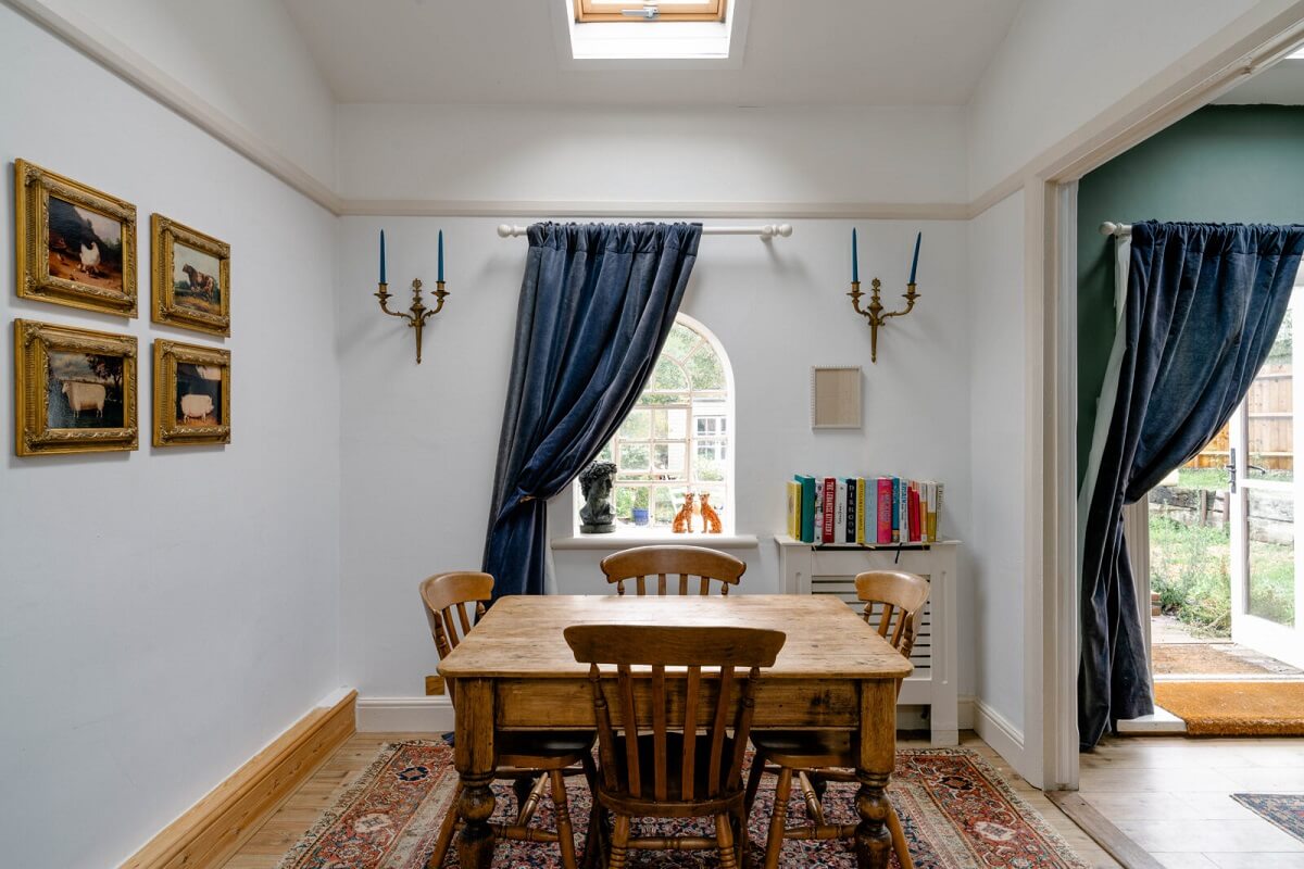 An English Barn Conversion Decorated in Green and Blue 5 dining-room-blue-curtains-skylight-nordroom