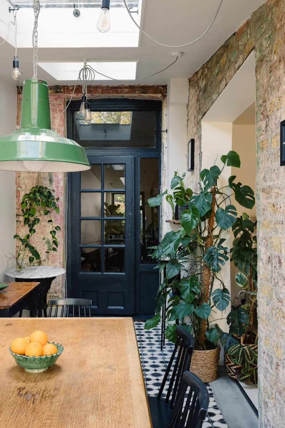 A Victorian House in London with Yellow Color Accents 8 dining-room-exposed-brick-wall-black-doors-skylight-nordroom