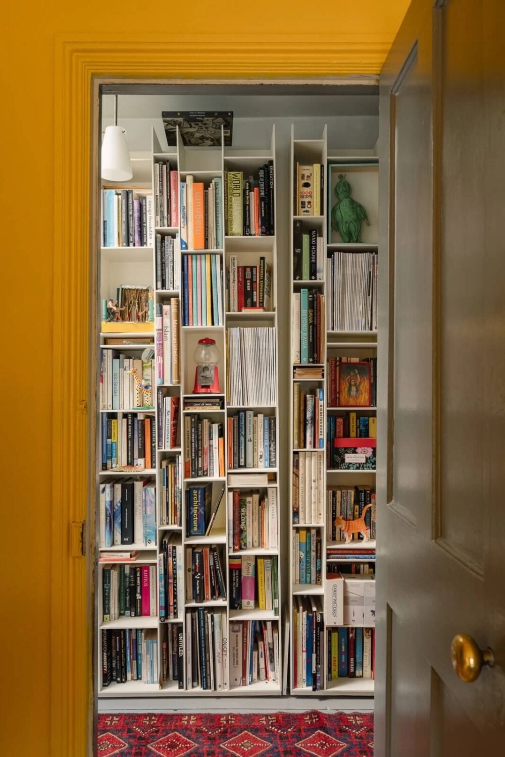 A Victorian House in London with Yellow Color Accents 22 hallway-bookshelves-pink-rug-nordroom