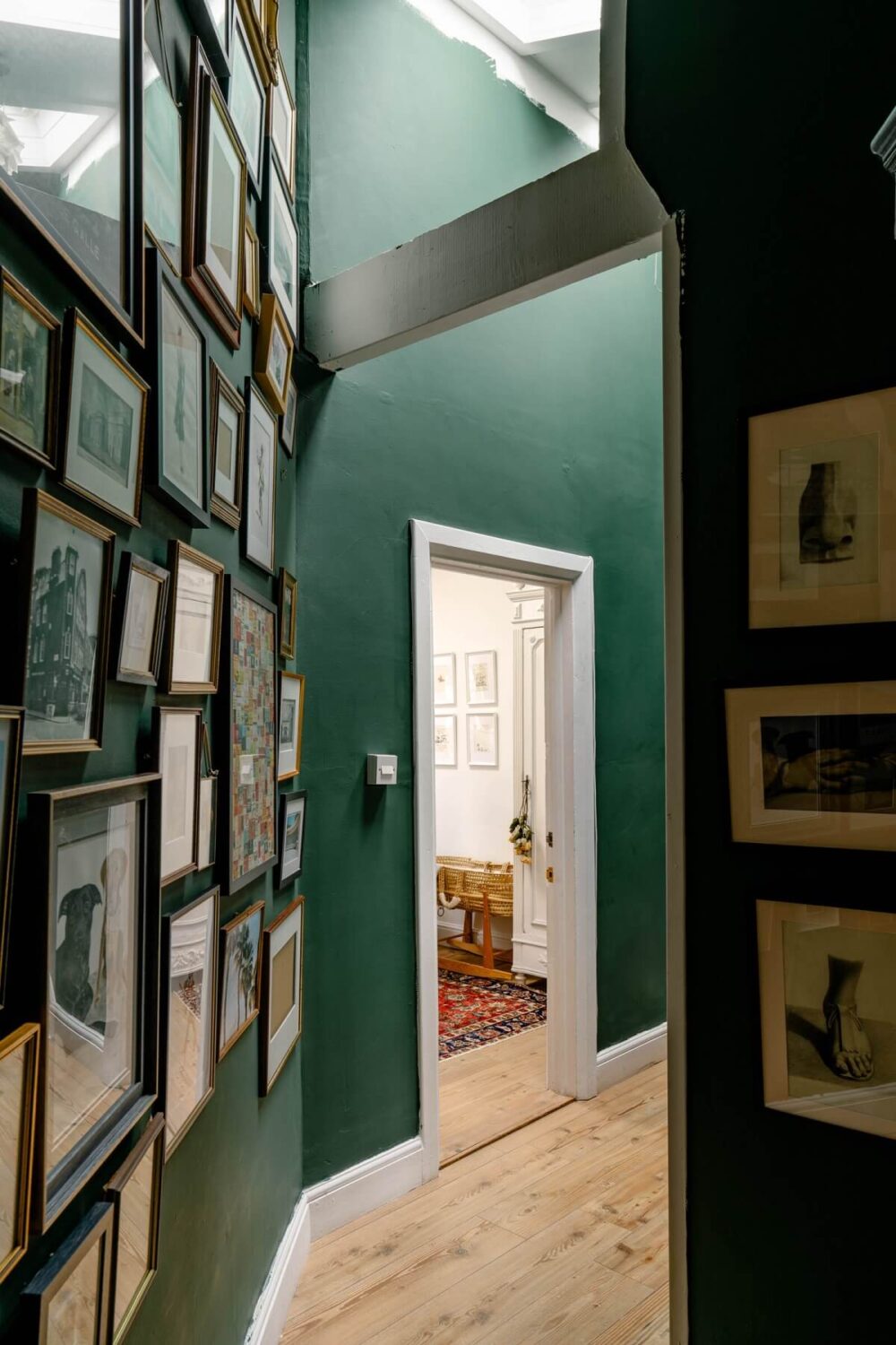 An English Barn Conversion Decorated in Green and Blue 10 hallway-green-walls-skylight-gallery-wall-nordroom