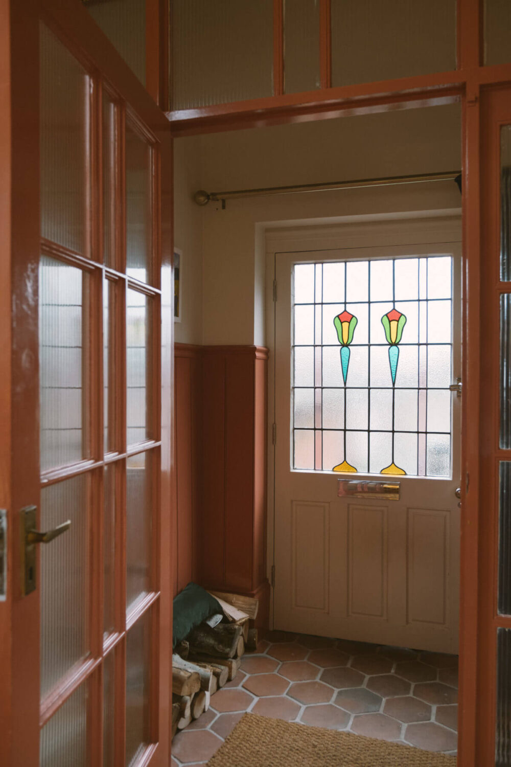 A Colorful Vintage Eclectic Home in England 32 hallway-salmon-pink-color-detail-terracotta-floor-tiles-nordroom