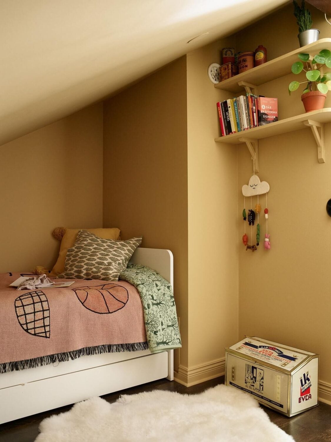 A Swedish Maisonette with a Charming Kitchen 18 kids-bedroom-yellow-walls-shelfs-slanted-ceiling-nordroom