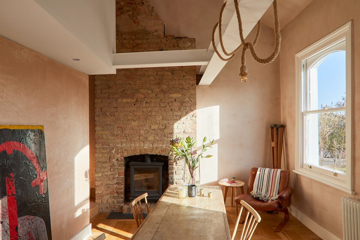 A London Home with Plaster Pink Walls and Brick Chimneys 5 kitchen-dining-space-exposed-brick-wall-firpelace-high-ceiling-nordroom