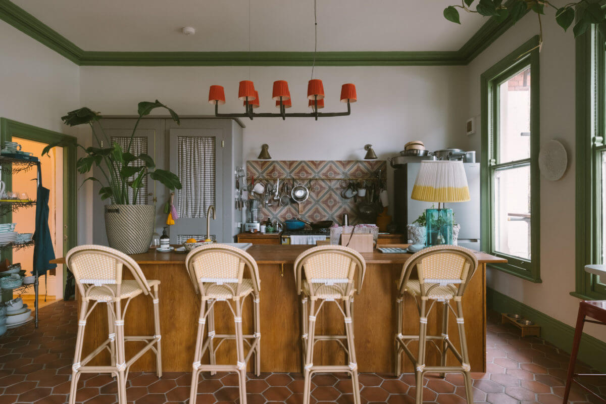 A Colorful Vintage Eclectic Home in England 10 kitchen-island-breakfast-bar-green-trimmings-handmade-terracotta-floor-tiles-nordroom